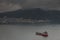 Red ship close to stormy shore in Busan, South Korea.