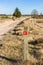 Red sign pointing to the walking direction in Drents Friese Wold National Park