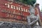 Red Sign Thailand Text with stone and marble gray statue pray cl