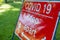 A red sign warning about the Coronavirus pandemic and social distancing at an outdoor event as lockdown eases in England
