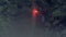 Red signal fire. Stock footage. Hiker got lost in woods during hike and now he`s waving red flare. Traveler waves signal