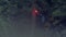 Red signal fire. Stock footage. Hiker got lost in woods during hike and now he`s waving red flare. Traveler waves signal