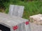 Red signs of wheelchairs and strollers on a wooden table in garden