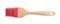 Red silicone brush with wooden handle isolated, top view. Cooking utensil