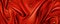 Red silk draped fabric background with gold pearls