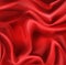 Red silk folded fabric background, luxury textile