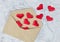 Red silk hearts in open postal envelope