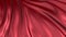 Red silk in slow motion. The fabric develops smoothly in the wind