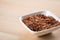 Red skinned raw Jasmine rice in porcelain bowl on wooden background