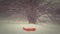 Red sled abandoned on the snow