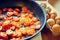 Red sliced â€‹â€‹tomatoes fried in a pan for cooking scrambled eggs