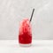 Red Slushie - drink with cherry juice. Refreshing summer drink. Sweet shaved ice or Spanish granizado in clear glass with drinking