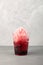 Red Slushie - drink with natural juice. Sweet shaved ice or Spanish granizado in disposable plastic cup, close-up. Refreshing