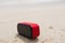Red small portable speaker outdoors
