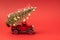 Red small retro toy truck with sparkling Christmas tree lights on truck body on red background. Delivery. Christmas, New