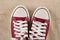Red sneakers on old fabric retro background