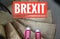 Red sneakers on spiral staircase when going downhill with inscription Brexit symbolizing the withdrawal of Great Britain from the