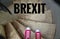 Red sneakers on spiral staircase when going downhill with inscription Brexit symbolizing the withdrawal of Great Britain from the
