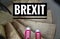 Red sneakers on spiral staircase when going downhill with inscription Brexit symbolizing the withdrawal of Great Britain from the