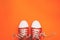 Red sneakers with untied laces with copy space. Youth sneakers on an orange background. Top view, flat lay