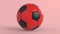 Red soccer plastic leather metal fabric ball isolated on black background. Football 3d render illlustration