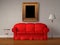 Red sofa with antique frame, table and stand lamp