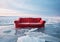 Red sofa over icy landscape. Winter atmosphere style, surreal. AI generative