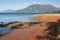 Red soil on lake Brunner shoreline