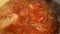 Red soup in a saucepan boils close
