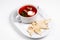 Red soup in a white plate. Borsch with bread appetizer