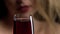 Red sparkling wine filling a glass. Slow motion. Women drinking a glass of red wine Black background