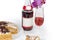 Red sparkling wine among sliced sponge cake against orchid