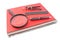 Red spiral notebook with drawing compass, ruler and magnifier is