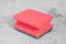 Red sponge for washing dishes on gray background. Cleaning, household, kitchen utensils