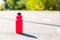 Red sport bottle on the running way