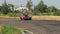 Red sport-looking vintage car Mercedes 450 SLC in international racing