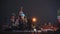 Red Square, few taxi cars drive past the Kremlin and Basil Church, winter, night