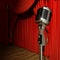 Red stage theater drapes and microphone