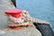 Red stand on the pier with a rope and tyre