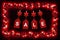 Red star christams lights on a dark wooden background with hanging tags spelling sale