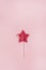 Red Star Shaped Lollipop on Light Pink Background Homemade Fruit Lollipop Candy Background Flat Lay Top View Vertical