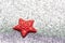 Red star on a silvery shiny background similar to ice. Festive card for the New Year and Christmas,
