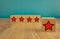 Red stars on wooden cubes on a blue background. Stars mean assessing quality. five-point rating system