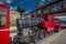 Red steam historic locomotive waiting in Schafbergspitze station in Austria