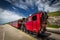 Red steam historic locomotive waiting in Schafbergspitze station near Salzburg