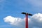 Red steel light poles in low angle view with flat PV solar panels on top