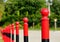 Red steel post and bollards in diminishing perspective. soft green background