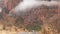 Red steep cliffs in Zion Canyon, Utah, USA. Hitchhiking trip, traveling in America, autumn journey. Rain, rocks and bare