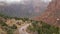 Red steep cliffs in Zion Canyon, Utah, USA. Hitchhiking trip, traveling in America, autumn journey. Rain, rocks and bare