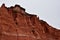 Red steep sandstone formations in Palo Duro Canyon State Park in Texas